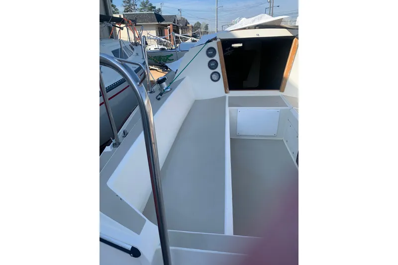 Slide: The Image of 1985 Oday 272 sailboat cockpit with steering wheel and cabin entrance. - 22