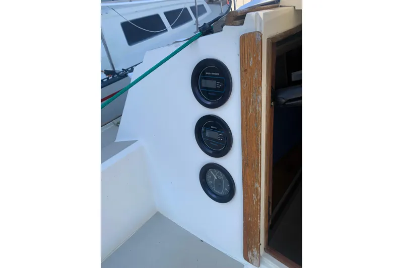 Slide: The Image of 1985 Oday 272 sailboat cockpit with navigation instruments and wooden trim. - 24