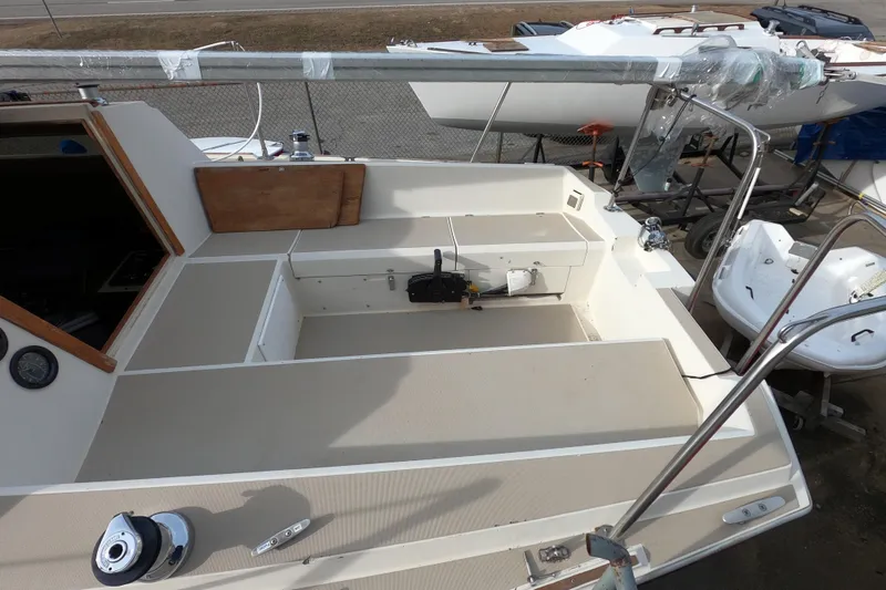 Slide: The Image of 1985 Oday 272 sailboat cockpit with seating and equipment, docked on land. - 7