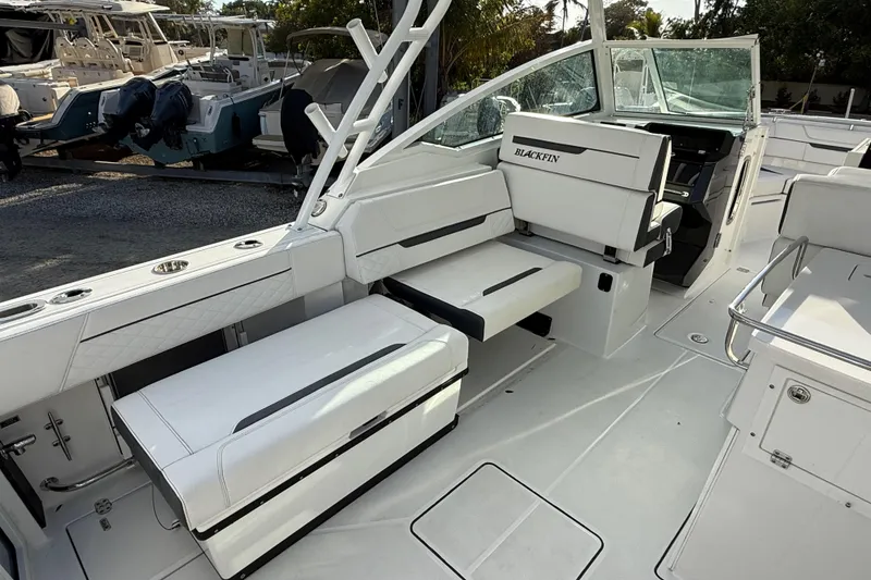 Slide: The Image of 2022 Blackfin 272 DC boat interior with white seating and modern design. - 10