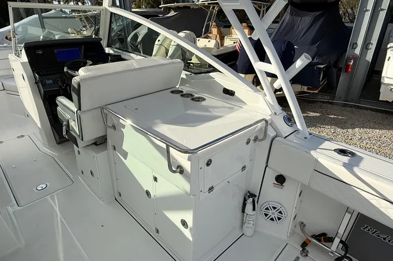 Slide: The Image of 2022 Blackfin 272 DC boat interior with helm, seating, and storage compartments. - 12