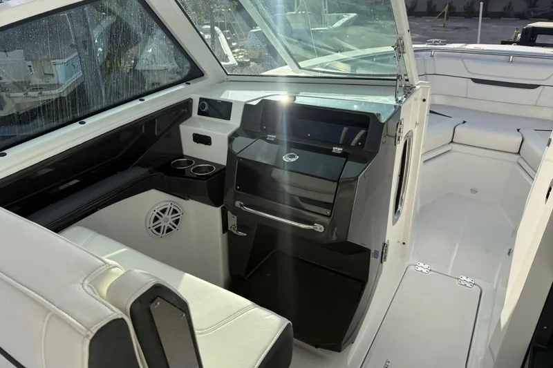 Slide: The Image of 2022 Blackfin 272 DC boat interior with seating and console, showcasing modern design. - 13