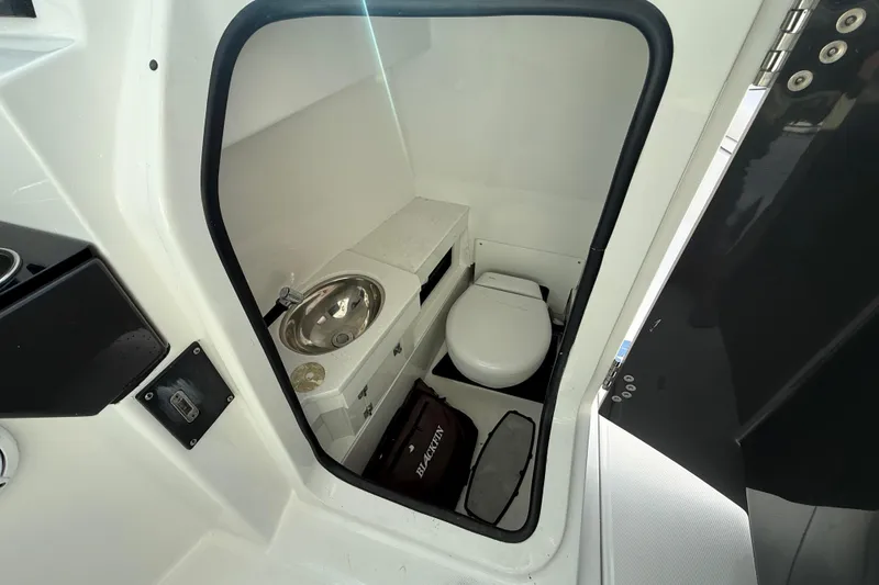 Slide: The Image of 2022 Blackfin 272 DC boat interior with compact bathroom and sink. - 18