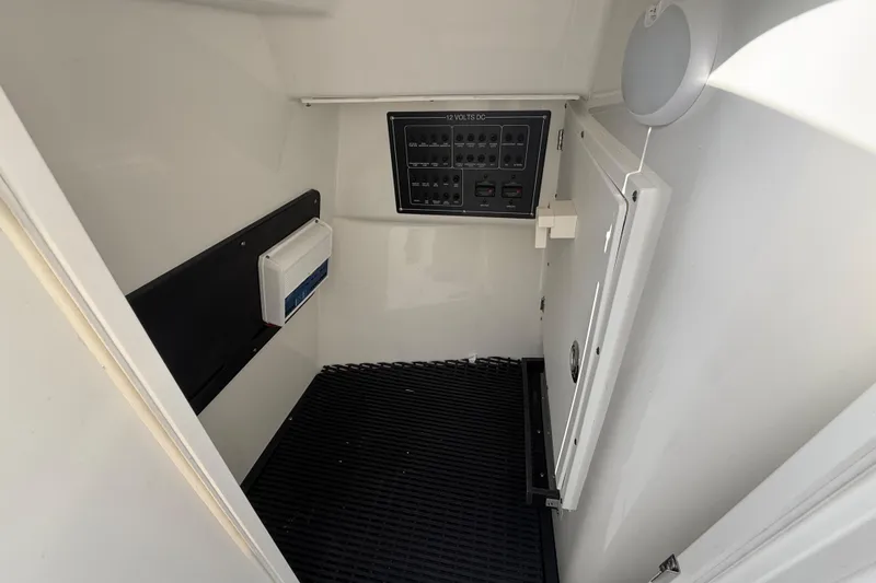 Slide: The Image of 2022 Blackfin 272 DC interior with control panel and storage compartment. - 19