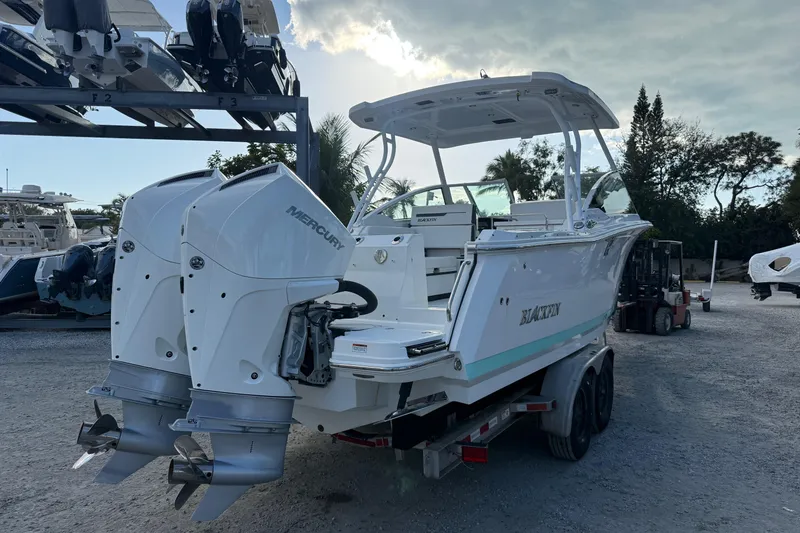 Slide: The Image of 2022 Blackfin 272 DC boat with dual Mercury engines on a trailer. - 4