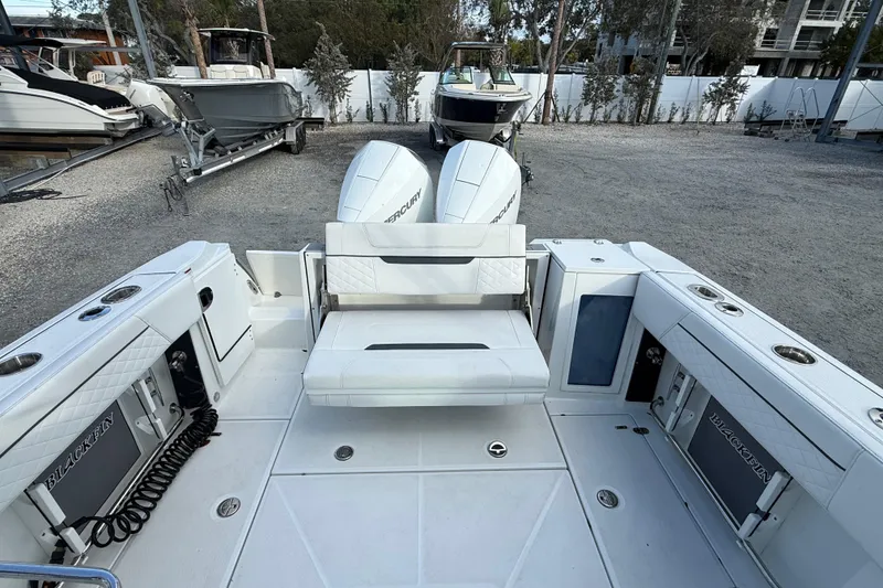 Slide: The Image of 2022 Blackfin 272 DC boat with dual Mercury engines, spacious seating, and sleek design. - 8