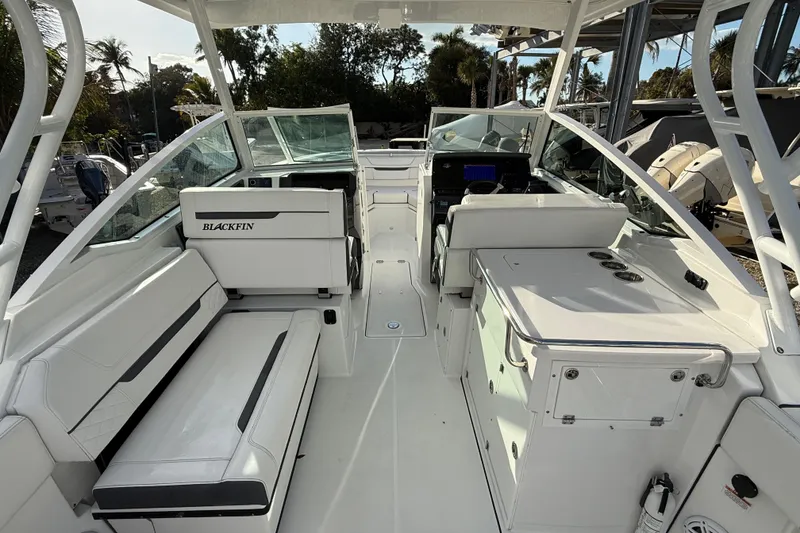 Slide: The Image of 2022 Blackfin 272 DC boat interior with seating and helm, showcasing modern design. - 9