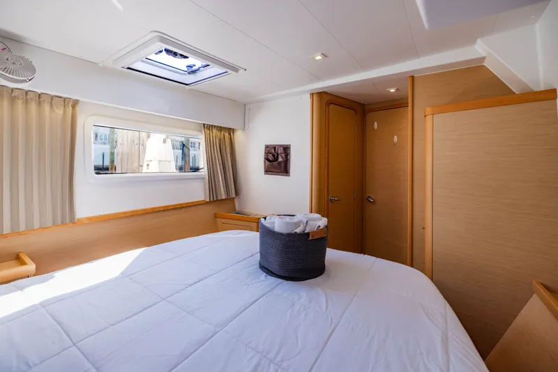 Slide: The Image of Interior of a 2018 Lagoon 42 yacht featuring a cozy bedroom. - 25
