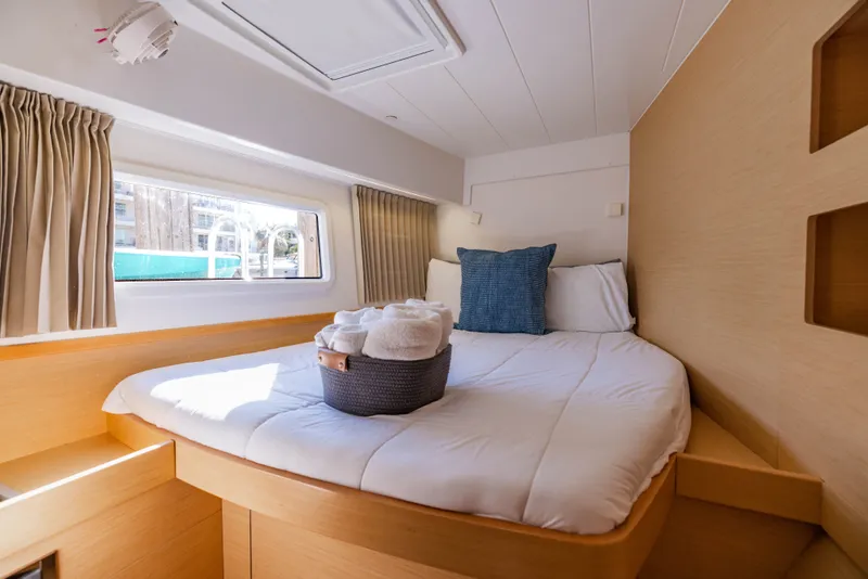 Slide: The Image of Interior of Lagoon 42 yacht, cozy bedroom with window. - 29