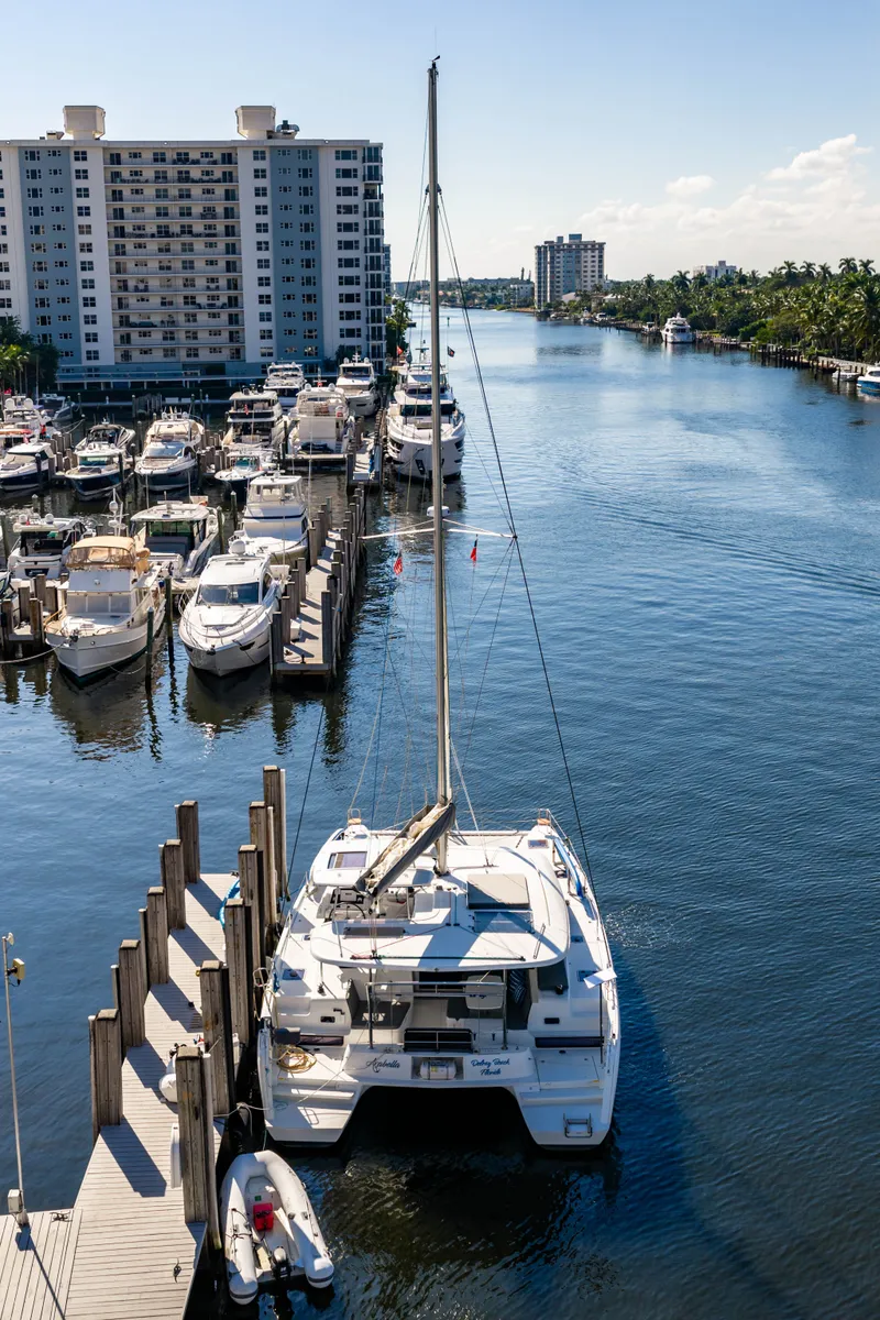Slide: The Image of 2018 Lagoon 42 catamaran docked in a marina. - 3