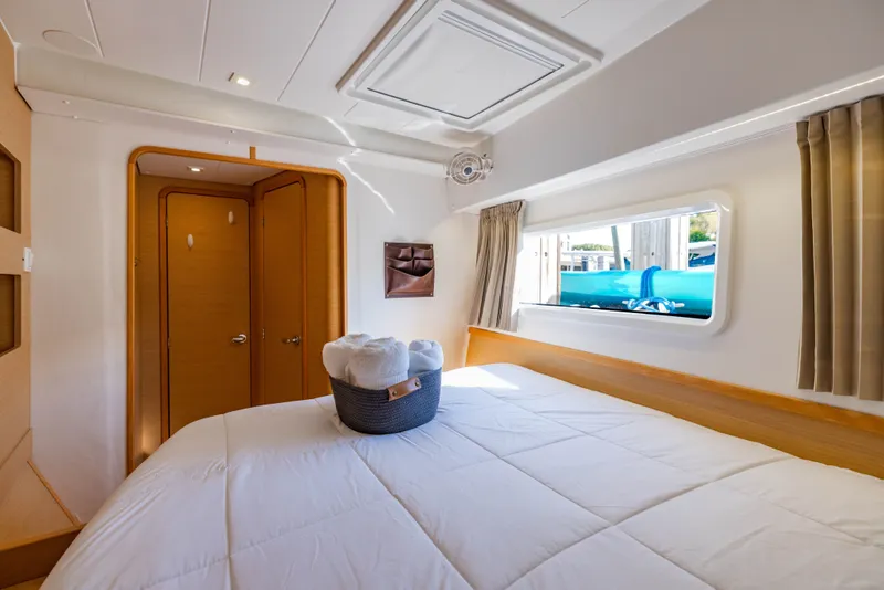 Slide: The Image of Interior of a 2018 Lagoon 42 yacht featuring a cozy bedroom. - 31