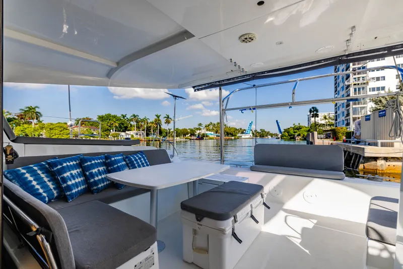 Slide: The Image of Lagoon 42 catamaran 2018, interior view with seating area and water view. - 41