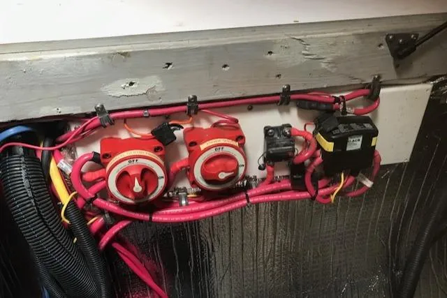 Slide: The Image of Electrical panel with red wiring in a 2005 Manta 42 MK II boat. - 19