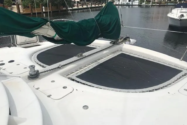 Slide: The Image of 2005 Manta 42 MK II catamaran deck with green sail cover, docked in marina. - 5