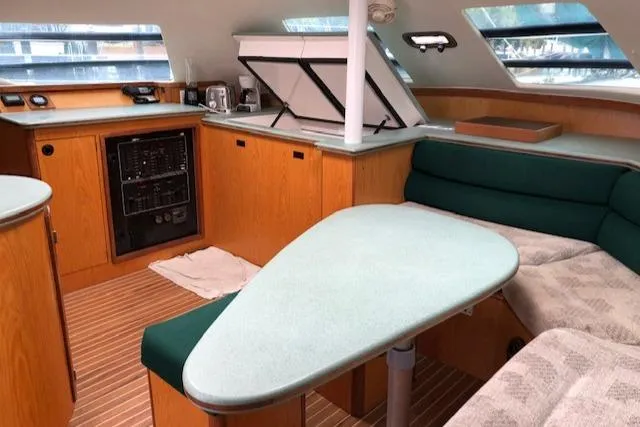 Slide: The Image of 2005 Manta 42 MK II yacht interior with modern kitchen and cozy seating area. - 9