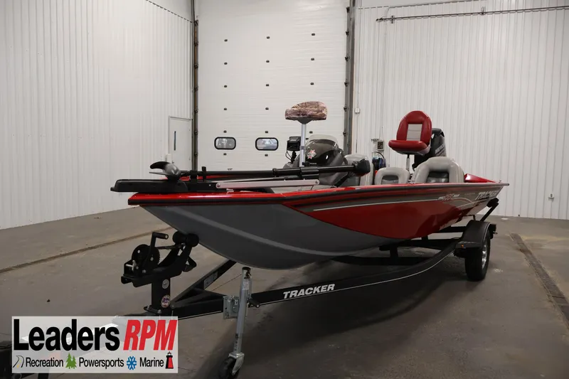 The Image of 2018 Tracker Pro Team 175 TXW boat in showroom, red and gray design, Leaders RPM logo. - 1