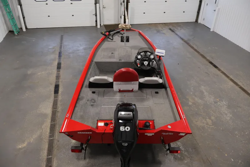 Slide: The Image of 2018 Tracker Pro Team 175 TXW boat in a garage, featuring a Mercury engine. - 10