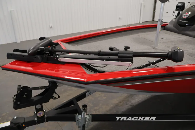 Slide: The Image of 2018 Tracker Pro Team 175 TXW boat with trolling motor, red exterior, on trailer. - 11
