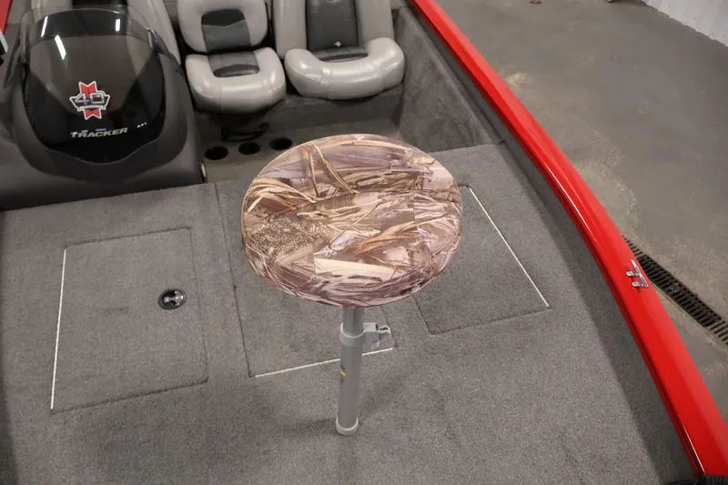 Slide: The Image of 2018 Tracker Pro Team 175 TXW boat interior with camo seat and red trim. - 13