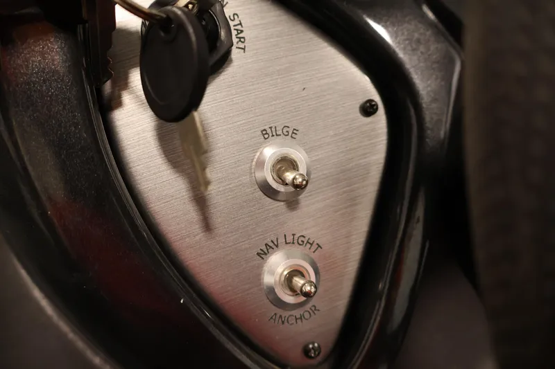 Slide: The Image of Control panel of 2018 Tracker Pro Team 175 TXW boat with switches and key. - 22