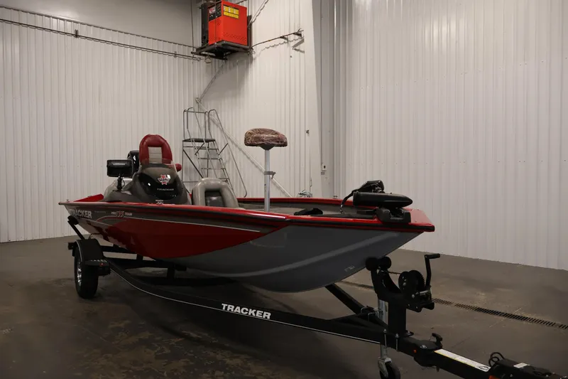 Slide: The Image of 2018 Tracker Pro Team 175 TXW boat in a garage, red and gray design. - 3
