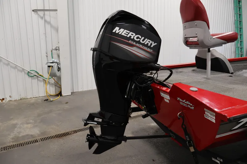 Slide: The Image of 2018 Tracker Pro Team 175 TXW with Mercury FourStroke outboard motor in a garage setting. - 32