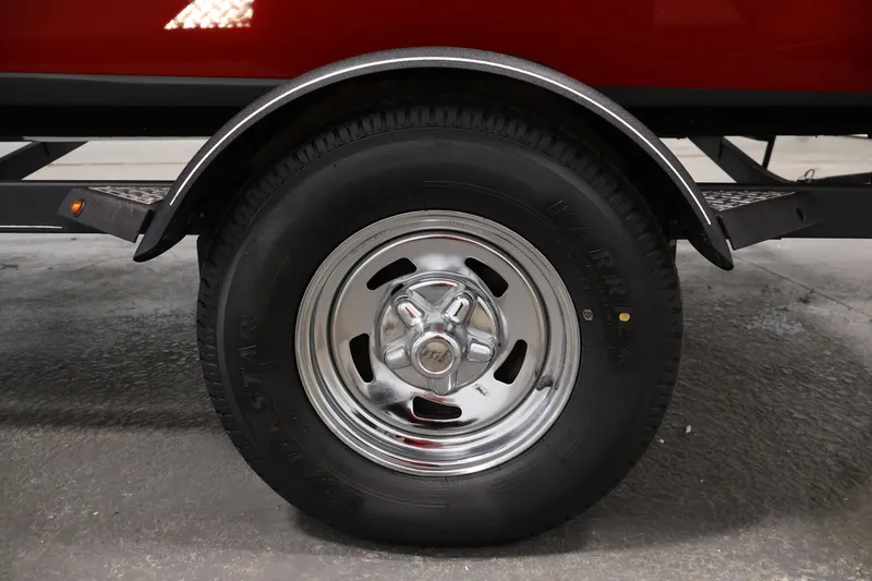 Slide: The Image of 2018 Tracker Pro Team 175 TXW trailer wheel with chrome rim and black tire. - 37