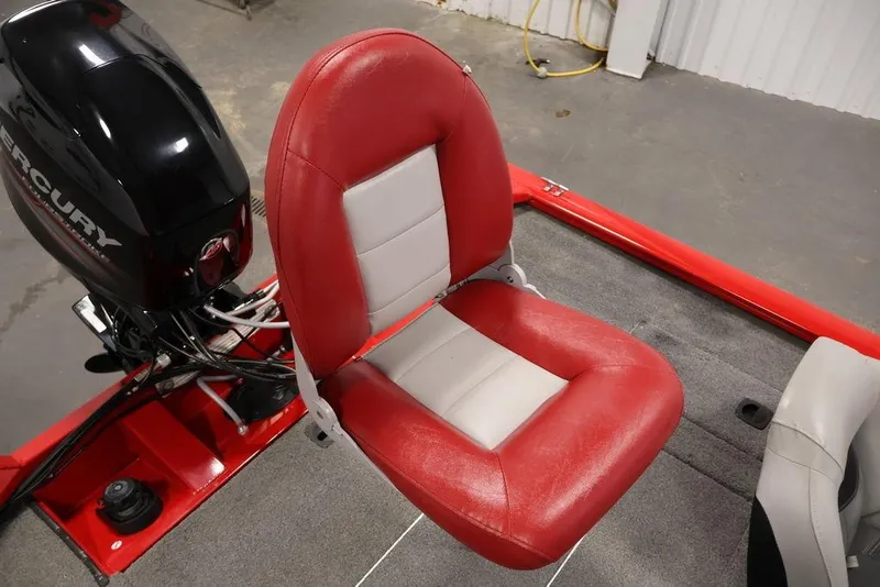 Slide: The Image of 2018 Tracker Pro Team 175 TXW boat seat with red and gray upholstery, Mercury engine visible. - 43