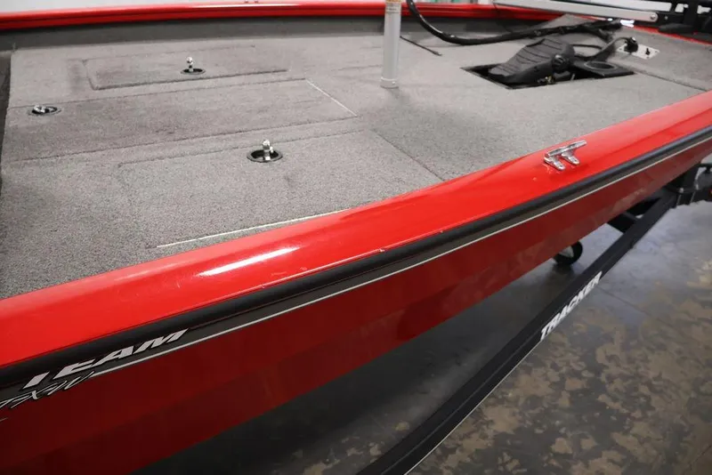 Slide: The Image of 2018 Tracker Pro Team 175 TXW boat, red exterior, carpeted deck, visible storage compartments. - 46