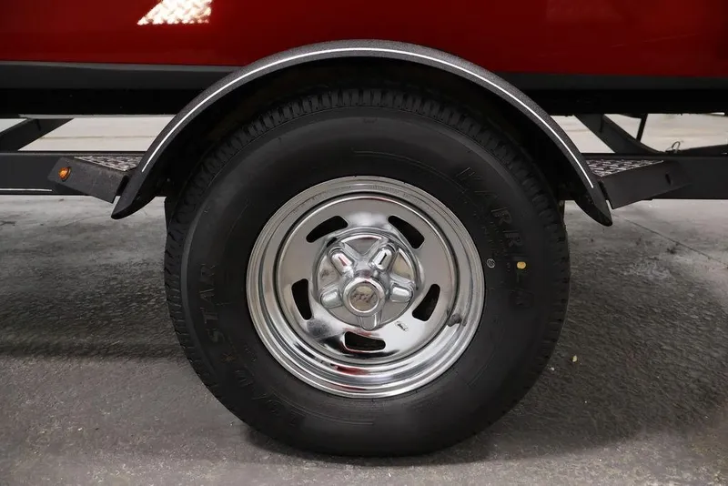 Slide: The Image of 2018 Tracker Pro Team 175 TXW trailer wheel with chrome rim and black tire. - 47