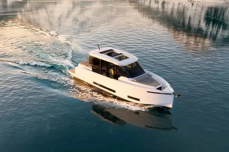 Slide: The Image of De Antonio Yachts D36 CABIN 2026 cruising on calm water. - 2