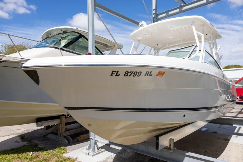 The Image of 2018 Robalo R247 Dual Console boat on a lift, sunny day. - 0