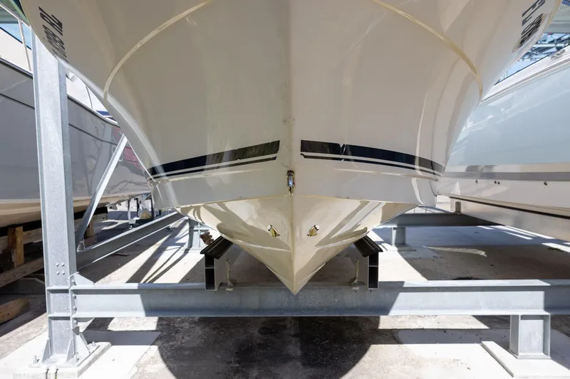 Slide: The Image of 2018 Robalo R247 Dual Console boat on storage rack, viewed from front. - 1