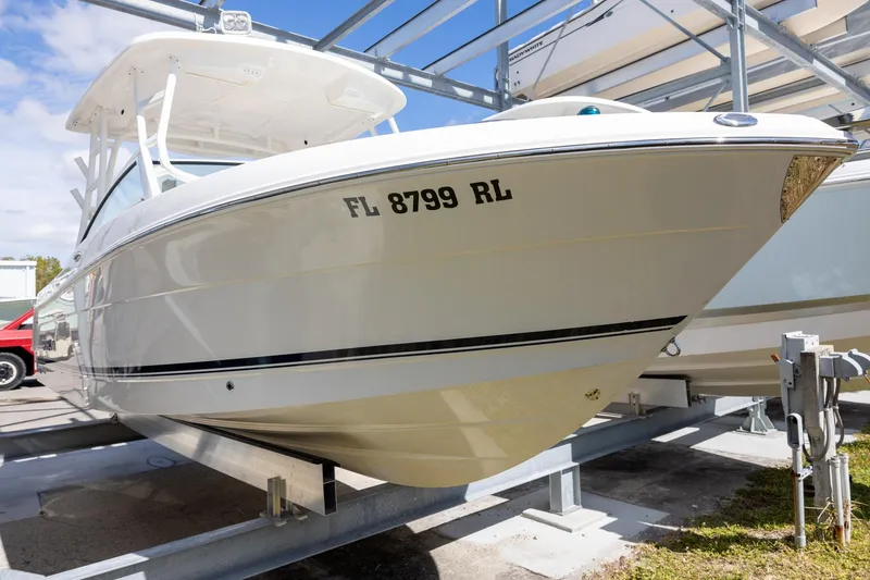 Slide: The Image of 2018 Robalo R247 Dual Console boat on trailer, side view. - 2