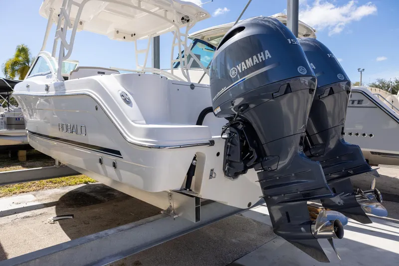 Slide: The Image of 2018 Robalo R247 Dual Console boat with twin Yamaha engines on display. - 3