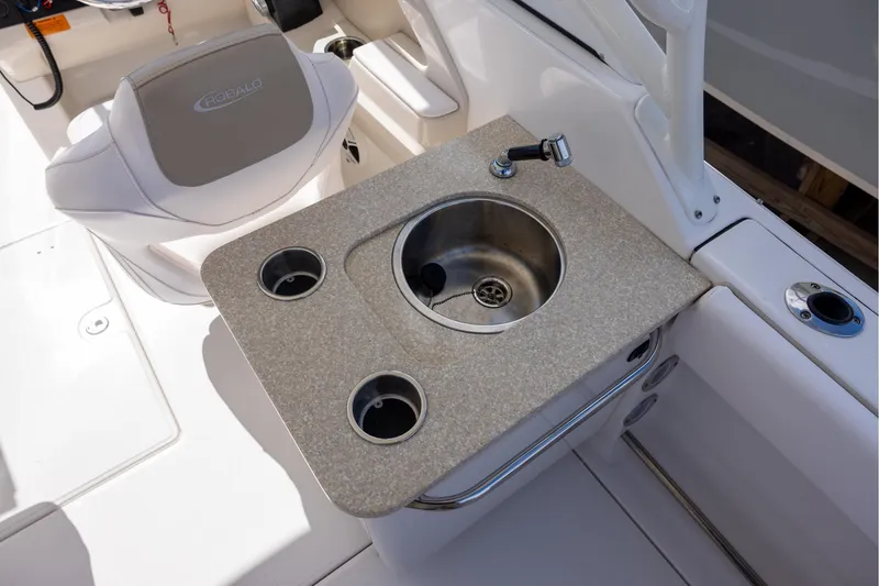 Slide: The Image of 2018 Robalo R247 Dual Console boat sink and seating area. - 9