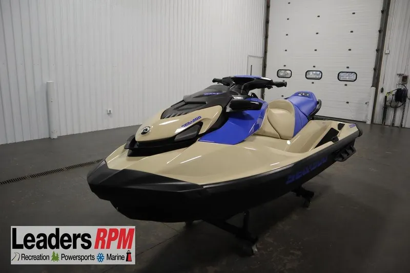 The Image of 2025 Sea-Doo Wake 170 jet ski in showroom, featuring beige and blue design. - 1