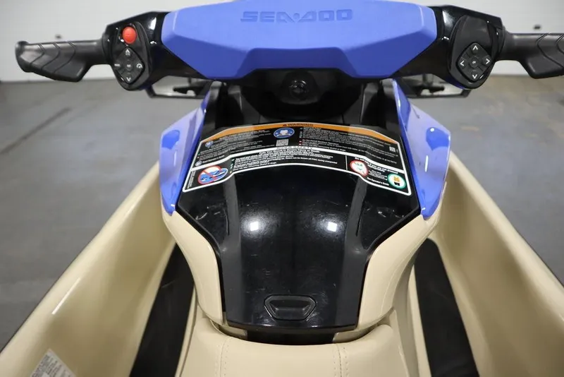 Slide: The Image of 2025 Sea-Doo Wake 170 handlebars and dashboard, featuring control buttons and warning labels. - 12