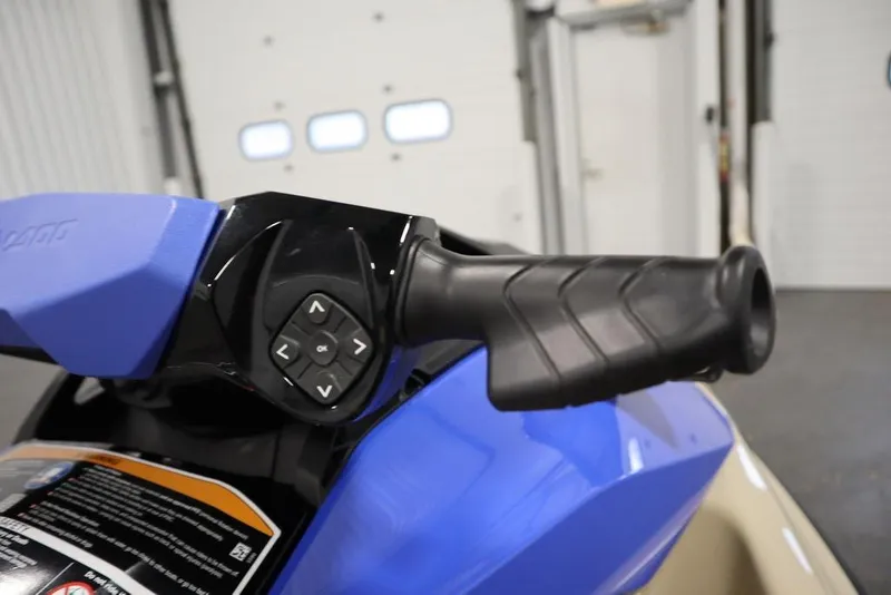 Slide: The Image of 2025 Sea-Doo Wake 170 handlebar with control buttons, featuring a sleek blue design. - 13