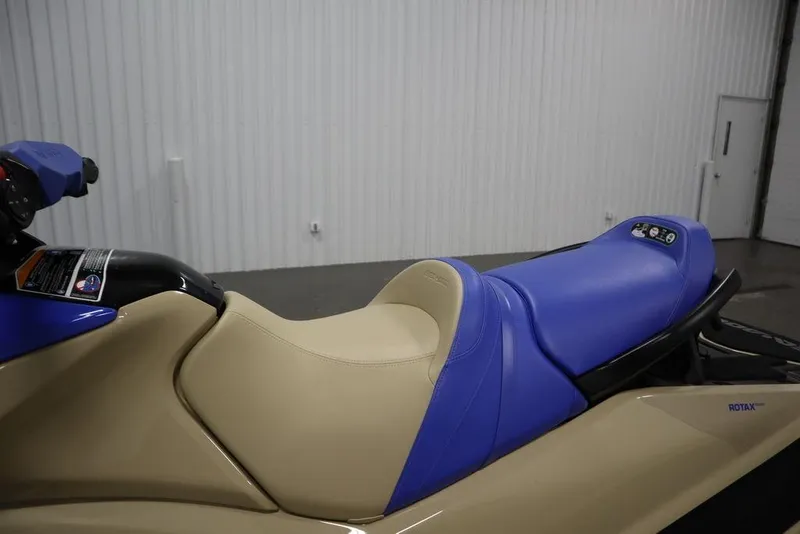 Slide: The Image of 2025 Sea-Doo Wake 170 jet ski with beige and blue seating in a garage setting. - 17