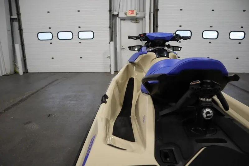 Slide: The Image of 2025 Sea-Doo Wake 170 jet ski in a garage, showcasing sleek design and blue seating. - 18