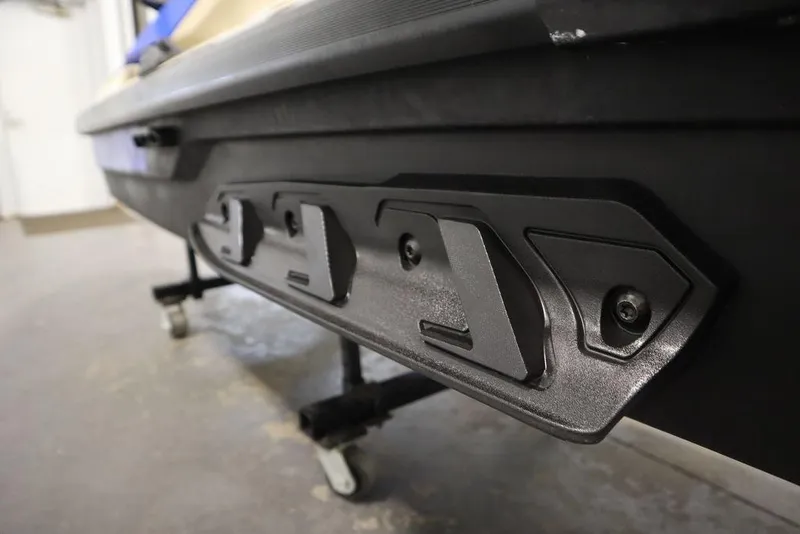 Slide: The Image of 2025 Sea-Doo Wake 170 close-up of hull detail in a garage setting. - 20