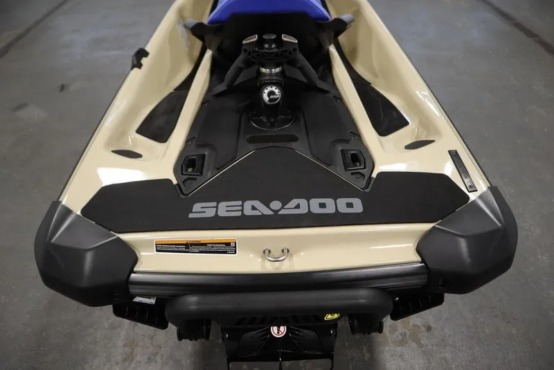 Slide: The Image of 2025 Sea-Doo Wake 170 jet ski, beige and black, rear view in a garage. - 22