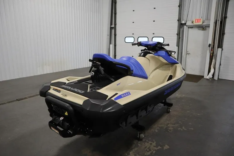 Slide: The Image of 2025 Sea-Doo Wake 170 jet ski in a garage, featuring blue and beige design. - 3