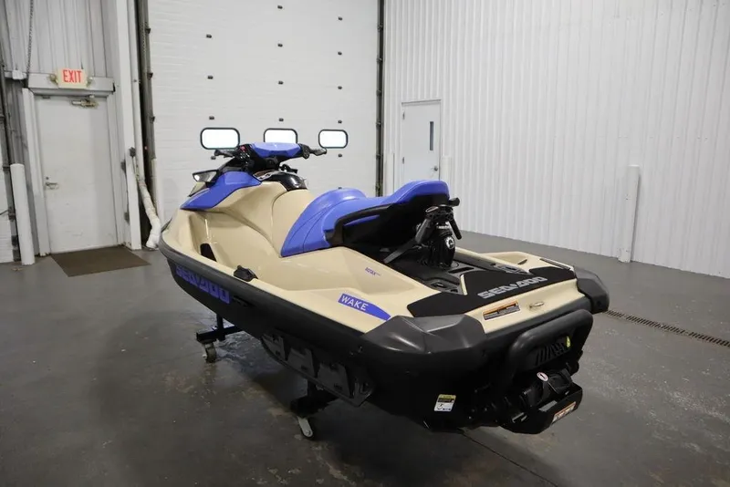 Slide: The Image of 2025 Sea-Doo Wake 170 jet ski in a garage, featuring a sleek design and vibrant colors. - 9