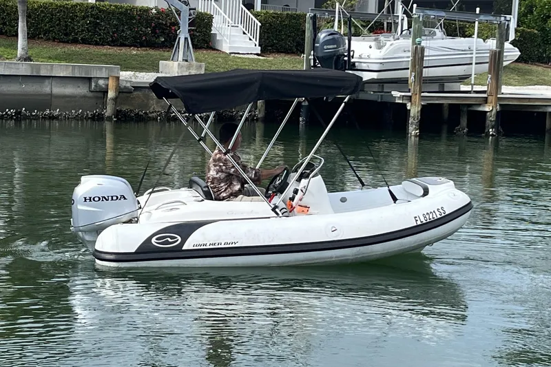 The Image of 2020 Walker Bay Generation 360 boat with Honda outboard motor on calm water. - 0