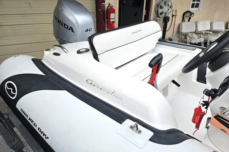 Slide: The Image of 2020 Walker Bay Generation 360 boat with Honda 40 engine, white interior, and sleek design. - 22