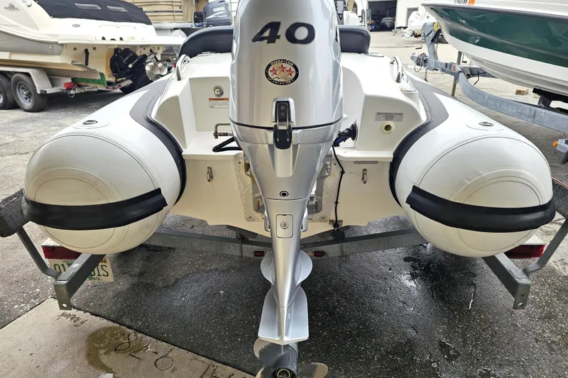 Slide: The Image of 2020 Walker Bay Generation 360 boat with outboard motor on trailer. - 23