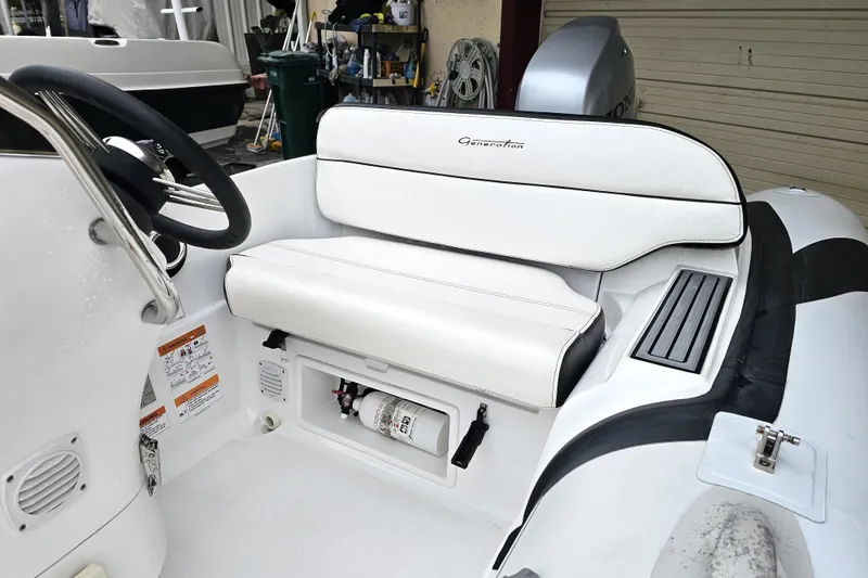 Slide: The Image of 2020 Walker Bay Generation 360 boat interior with white seating and steering wheel. - 27