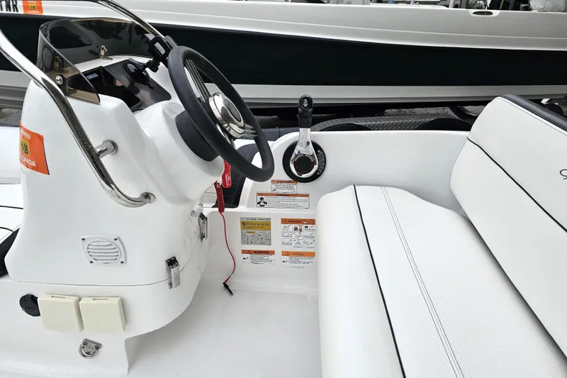 Slide: The Image of 2020 Walker Bay Generation 360 boat interior with steering wheel and seating. - 29